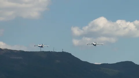 Two Be-200ES aircraft perform group flight over Gelendzhik Bay. Aerobatics. Stock Footage 125381851