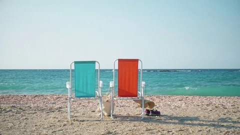 Two beach chairs and clothes on the shore of the Mediterranean Sea in Israel. 스톡 동영상 85001896