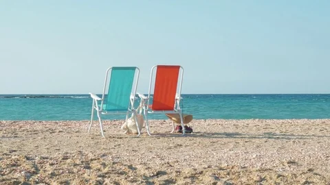 Two beach chairs and clothes on the shore of the Mediterranean Sea in Israel. 스톡 동영상 85004148