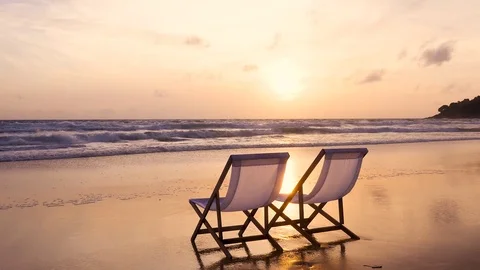 Two beach chairs on the beautiful sunset beach. Vidéo 79191278