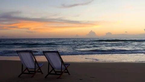 Two beach chairs on the beautiful sunset beach. Stock-Footage 93027140