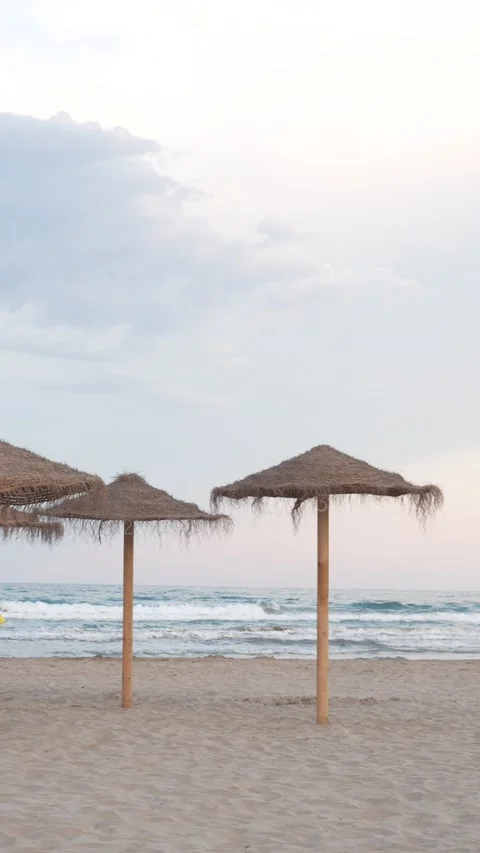 Two beach umbrellas are on the beach Stock Footage 278150600