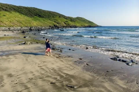Two beachgoers at Point Lance Beach Stock Photos