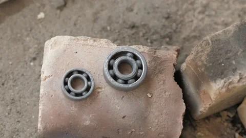 Two bearings cool down on the brick after the fire. hot bearings on fire Stock Footage 140323140
