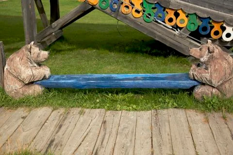 Two bears carved from a tree by the deck 스톡 사진