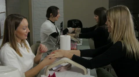 Two beauticians with two customers. Hands massage. Treatment in beauty salon. Stock Footage 59514088