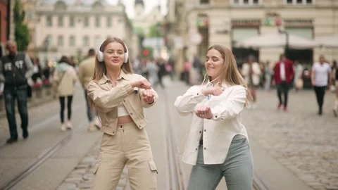 Two beautiful blonde womans shooting together dancing at city street when making Stock Footage 199826650