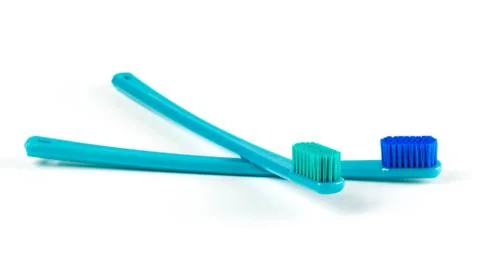 Two beautiful blue toothbrushes. Close up. Isolated on white background 库存照片