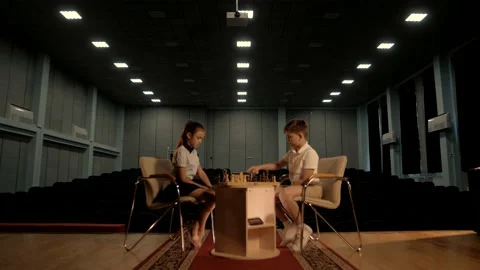 Two beautiful children playing chess in competition Stock Footage 156700565