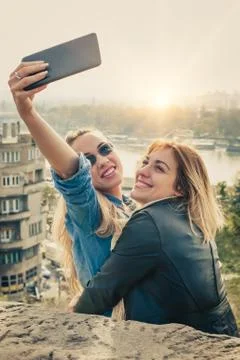 Two beautiful friends funny selfie on a tablet Stock-Fotos