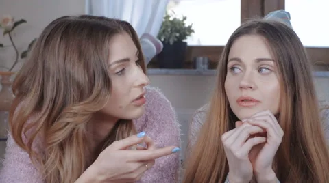 Two beautiful girls talking while lying on bed. 스톡 동영상 62340488