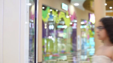 Two beautiful girls use the interactive panel to make a purchase at the mall. Stock Footage 90770561