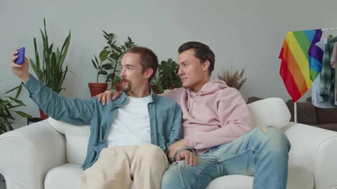 Two beautiful lgbt men are taking photos together on the phone, being in the Stock Footage 174466835