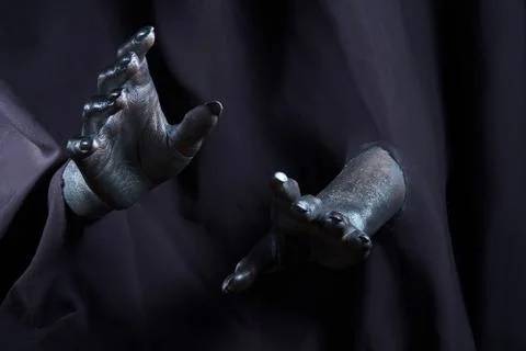 Two beautiful man's hands in silver paint on a black background Stock Photos