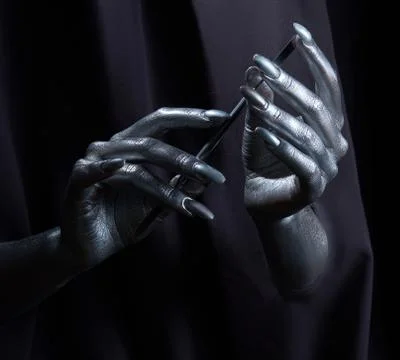 Two beautiful man's hands in silver paint on a black background Stock Photos