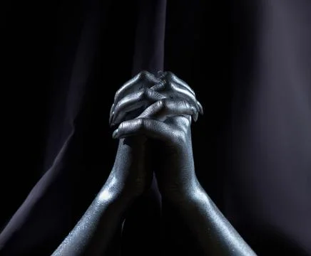 Two beautiful man's hands in silver paint on a black background Stock Photos