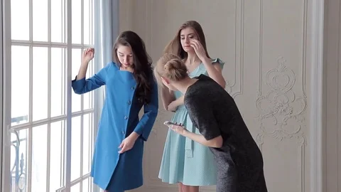 Two beautiful models in blue and light blue dresses posing to catalog photo Stock Footage 72660918