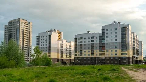 Two beautiful modern multi-storey buildings on the background of gray rainy c 库存照片
