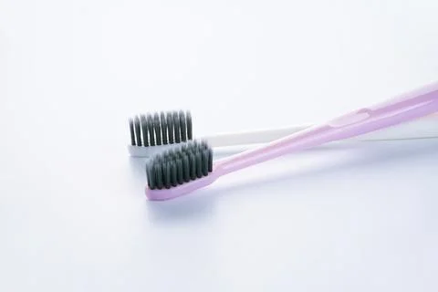 Two beautiful multi-colored toothbrushes with black shields, on a white backg Foto stock
