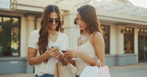 Two beautiful shopper girls text their friends about their day Stock Footage 101122958