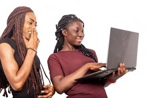 Two beautiful sisters using a laptop Stock Photos