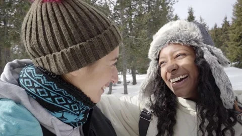 Two beautiful smiling girlfriends enjoy winter hiking day snow mountain Stock Footage 250422012