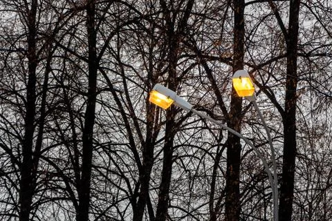 Two beautiful street yellow rectangular lighting lanterns with reflections on 스톡 사진
