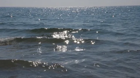 Two beautiful sunlit waves cresting and crashing. Slow motion. Lake Ontario. Stock Footage