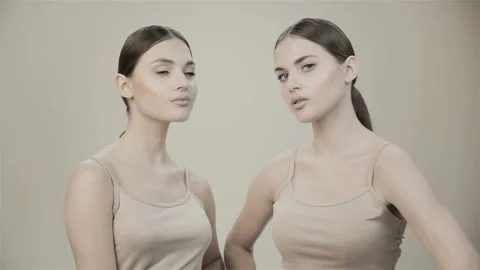 Two beautiful twin sisters in the studio.  Stock Footage 132879783