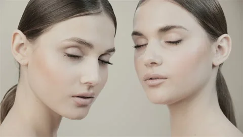Two beautiful twin sisters in the studio.  Stock Footage 132880277