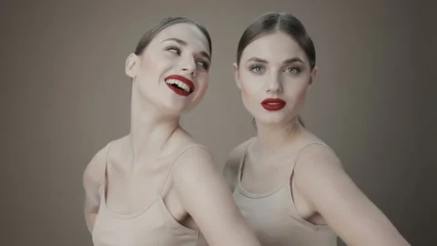 Two beautiful twin sisters in the studio... Stock Video Pond5