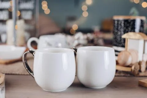 Two beautiful white cups on the festive table 스톡 사진