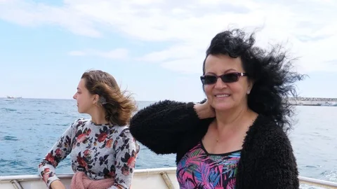 Two beautiful women having bumpy boat ride Stock Footage 107073637