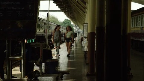 Two beautiful women talking while walking in railway station Stock Footage 75293159