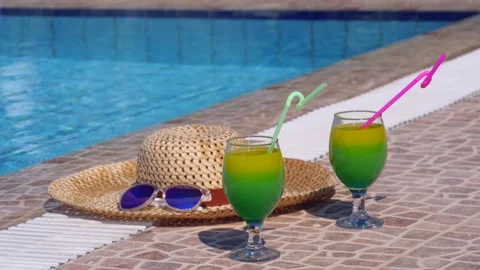 Two beautiful yellow-green-orange cocktails with straws, sunglasses and straw Stock Footage 130527461