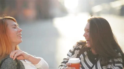 Two beautiful young chic stylish girls having fun outdoors. Attractive young Stock Footage 67819179