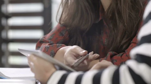 Two beautiful young girls studying at modern loft apartment. Stock Footage
