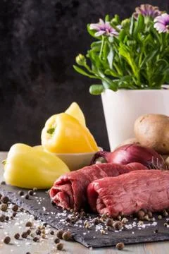 Two beef slices prepared for roulade on slate board Stock Photos