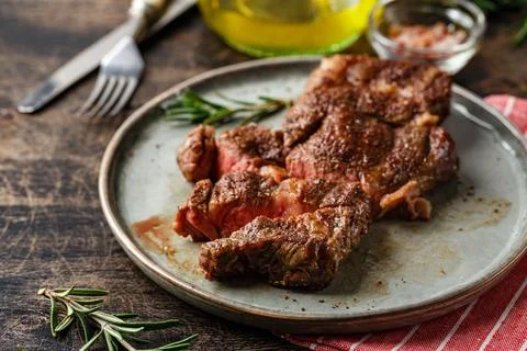 Two beef steak on dark gray background Stock Photos