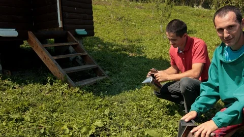Two beekeepers in special clothes hold a censer to calm the bees Stock-Footage 116044289