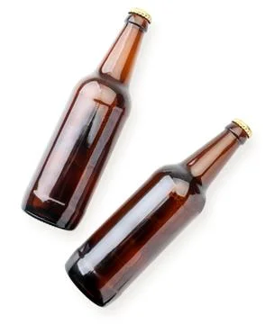 Two beer bottles close-up on a white background. The view from top Stock Photos