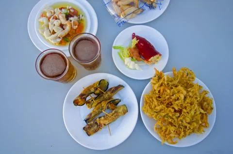 Two beers, plates with different snacks Stock Photos