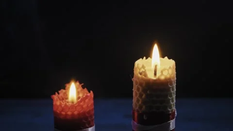 Two Beeswax Candles Burning And Extinguishing Against A Dark Background 스톡 동영상 329838078