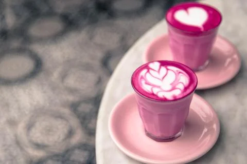 Two Beetroot color latte are on marble background. Stock Photos