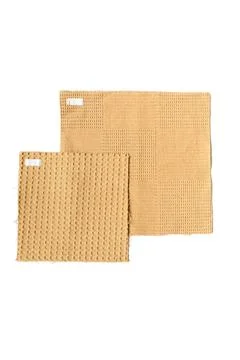 Two beige bath mats with textured surface on white background Stock Photos