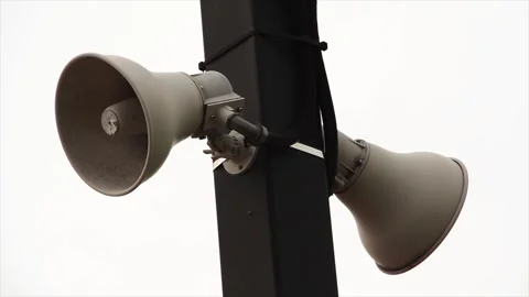 Two beige train station speakers pointing in opposite directions, fastened Stock Footage 246611788