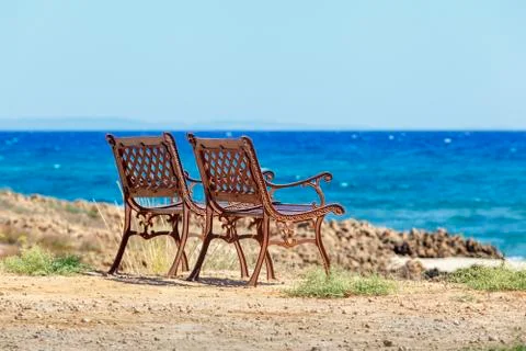 Two benches on the seafront Stock Photos