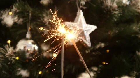 A Two Bengal Fire Sticks under a Christmas Tree at Home Stock Footage 145761037