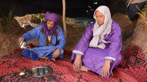 Two berber men having a mint tea ceremony at an oasis in the Sahara Stock Footage 49443915