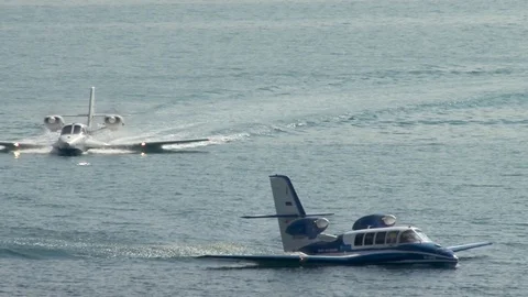 Two Beriev Be-103 light amphibious aircraft sail like boats towards shore. Stock Footage 124191543